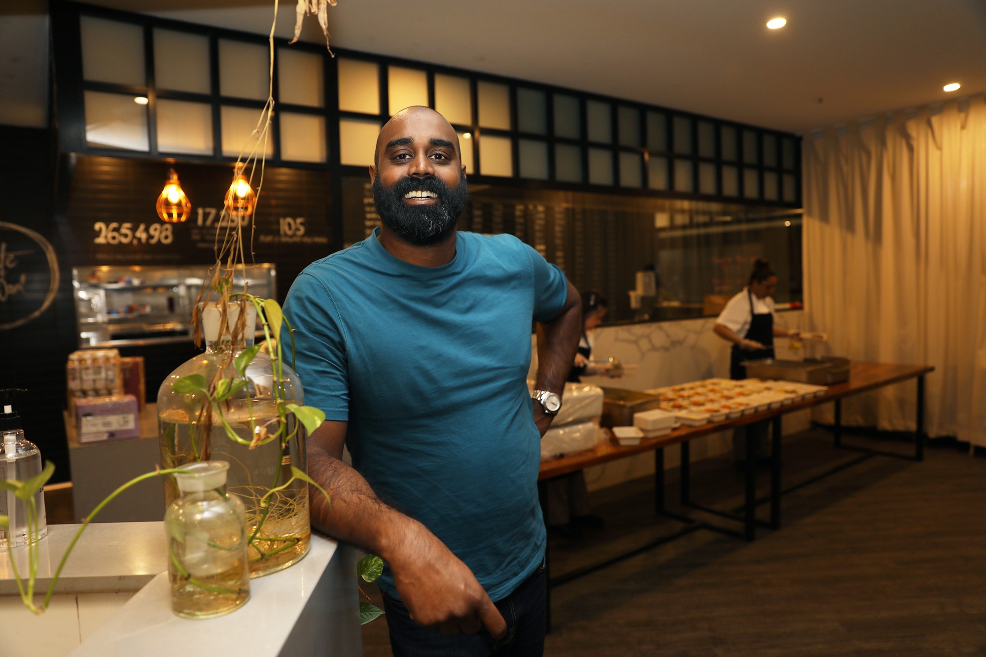 Man stand at edge of bar in restaurant